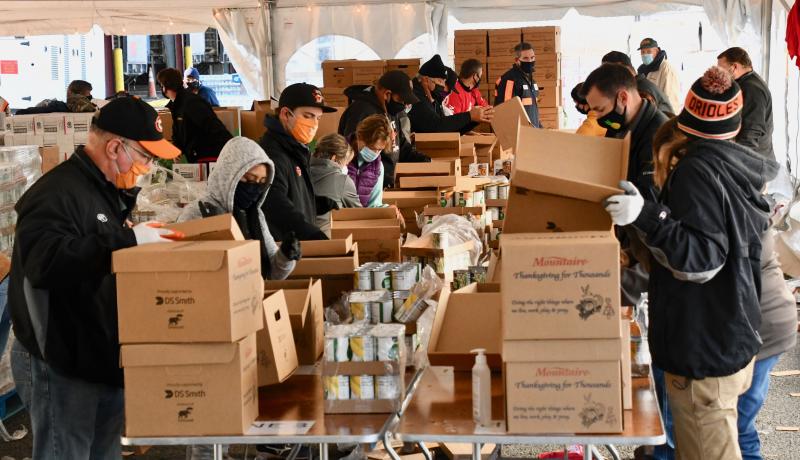 It’s non stop action as volunteers are busy packing food boxes under a large tent at Selbyville’s Mountaire Farms during the Thanksgiving for Thousands food project.